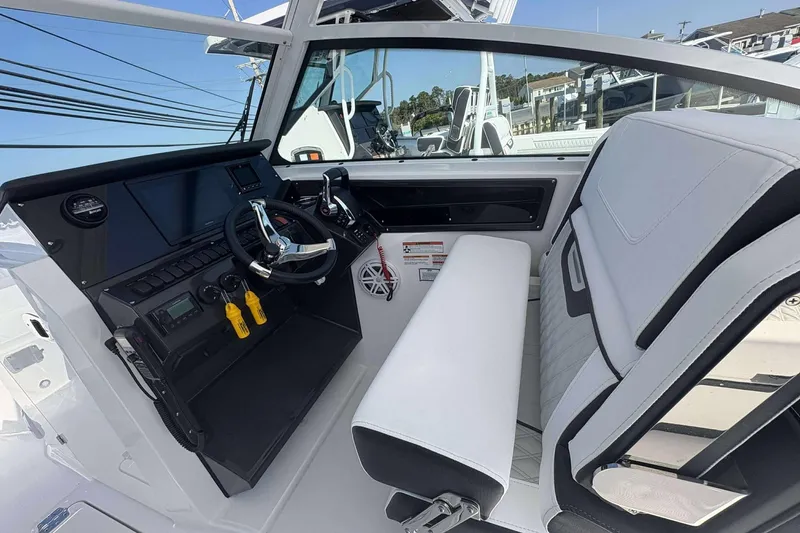 Slide: The Image of 2026 Blackfin 272 DC boat cockpit with modern steering and seating. - 8