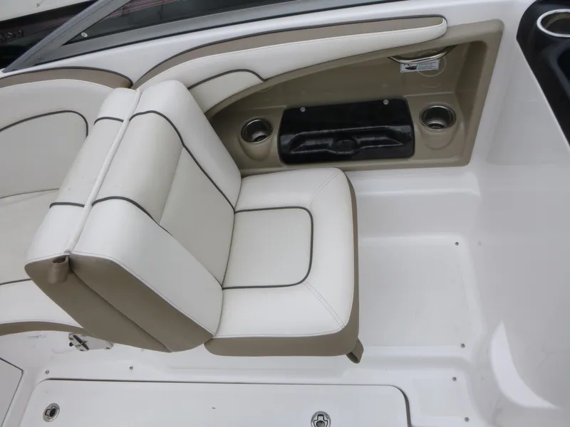 Slide: The Image of 2013 Yamaha Boats SX240 HO interior seating with white and beige upholstery. - 11