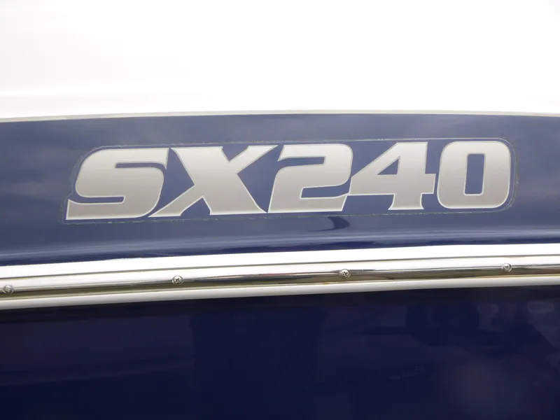 Slide: The Image of 2013 Yamaha Boats SX240 HO logo on blue and white surface. - 14