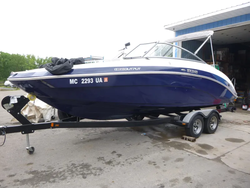 Slide: The Image of 2013 Yamaha Boats SX240 HO on trailer, parked outdoors. - 2