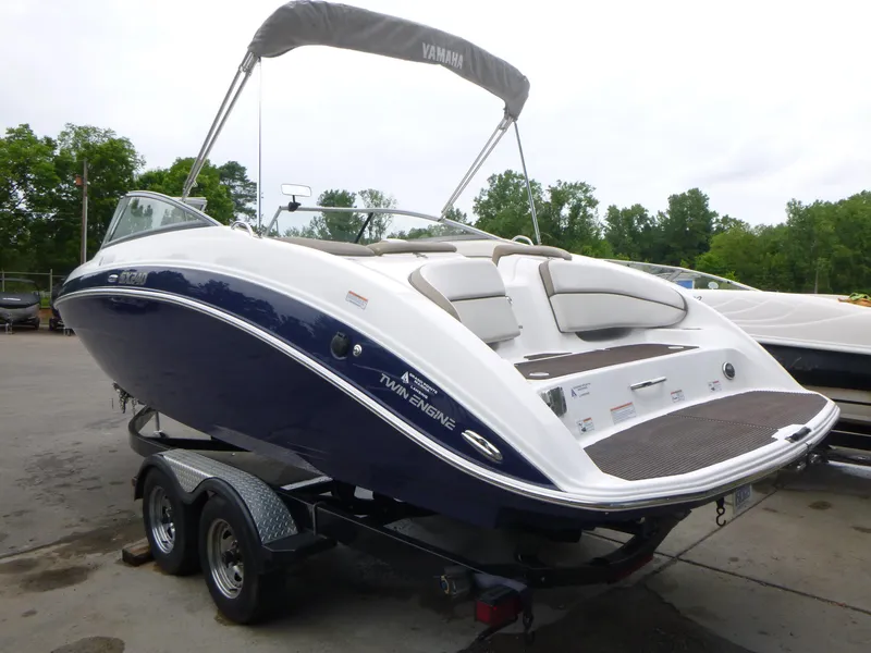 Slide: The Image of 2013 Yamaha SX240 HO boat on trailer, featuring sleek design and twin engines. - 3
