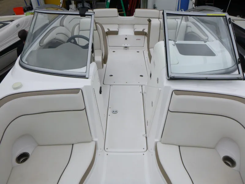Slide: The Image of 2013 Yamaha Boats SX240 HO interior with white seating and dual windshields. - 5