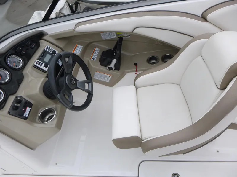 Slide: The Image of 2013 Yamaha Boats SX240 HO cockpit with steering wheel and control panel. - 6