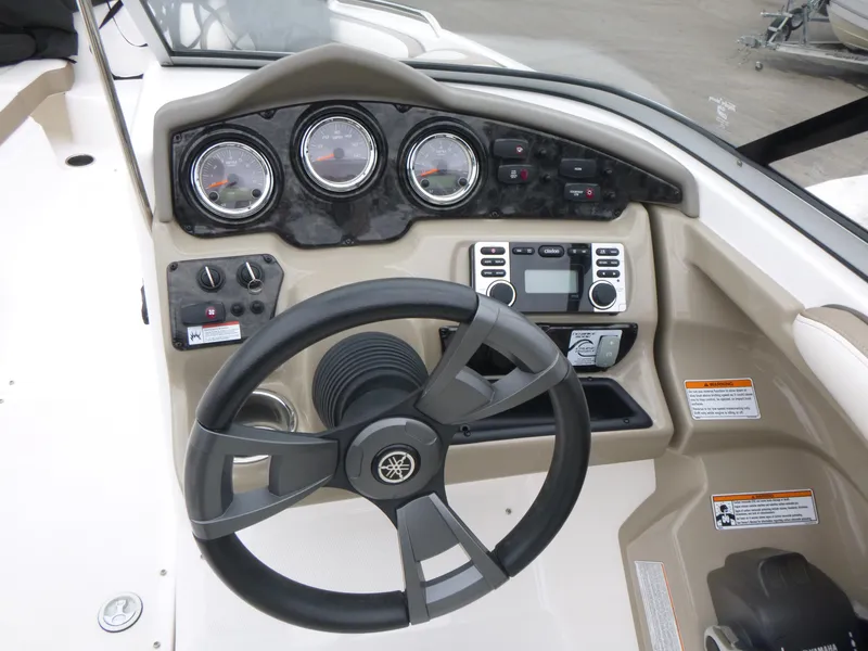 Slide: The Image of 2013 Yamaha Boats SX240 HO dashboard with steering wheel and control panel. - 7