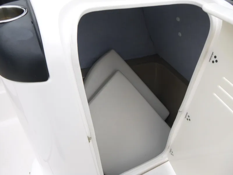 Slide: The Image of 2013 Yamaha SX240 HO boat storage compartment with cushions inside. - 9