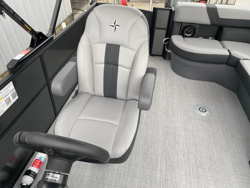 Slide: The Image of 2025 Berkshire 22 CL2 boat interior with gray captain's chair and seating area. - 13