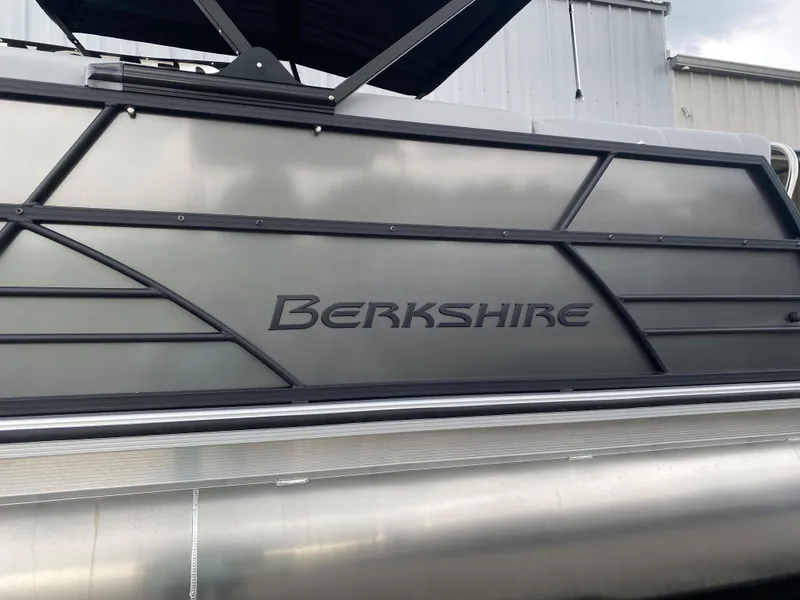 Slide: The Image of 2025 Berkshire 22 CL2 pontoon boat with sleek metallic design and branding. - 5
