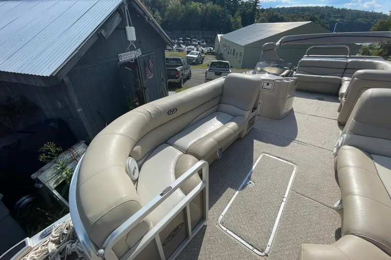 Slide: The Image of 2010 Harris Grand Mariner 240 pontoon boat with beige seating and spacious deck. - 14