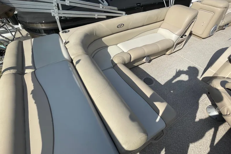 Slide: The Image of 2010 Harris Grand Mariner 240 boat interior with beige seating and cup holders. - 15