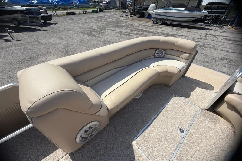 Slide: The Image of 2010 Harris FloteBote 240 Grand Mariner pontoon boat with beige seating in a marina. - 18