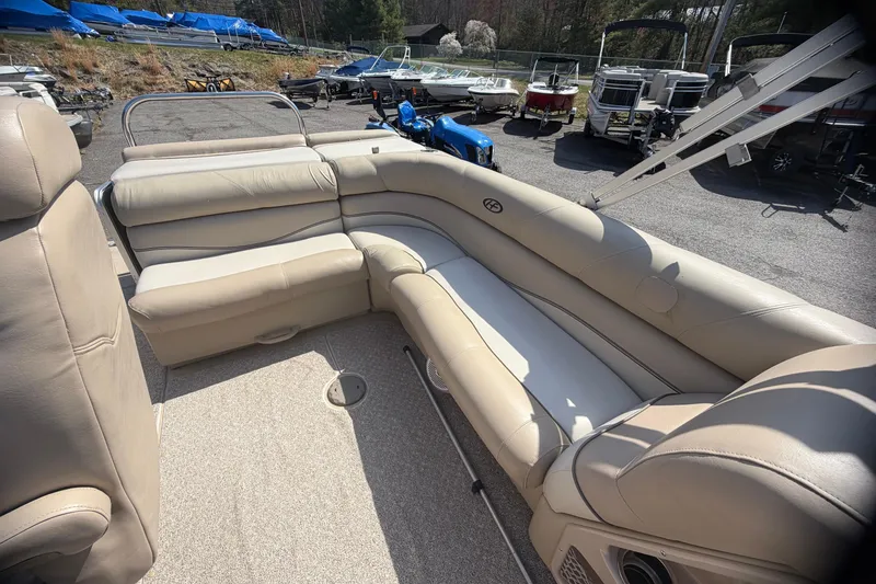 Slide: The Image of 2010 Harris FloteBote 240 Grand Mariner with beige seating in a boatyard. - 20