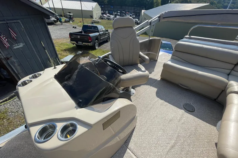 Slide: The Image of 2010 Harris Grand Mariner 240 boat interior with helm, seating, and dashboard. - 3