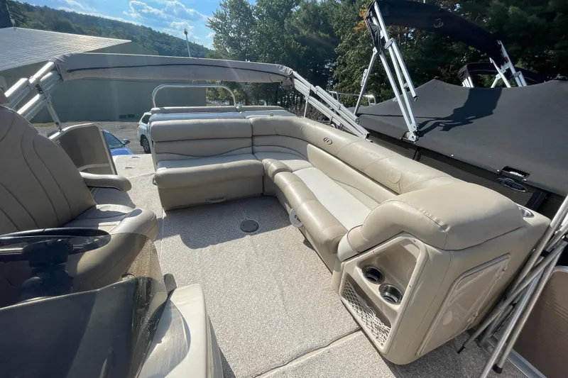 Slide: The Image of 2010 Harris Grand Mariner 240 boat interior with beige seating and cup holders. - 4
