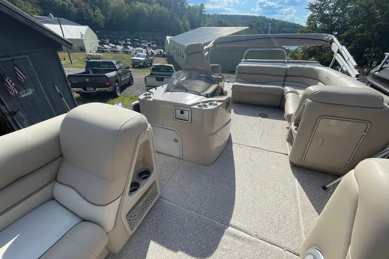 Slide: The Image of 2010 Harris Grand Mariner 240 pontoon boat interior with beige seating and cup holders. - 6