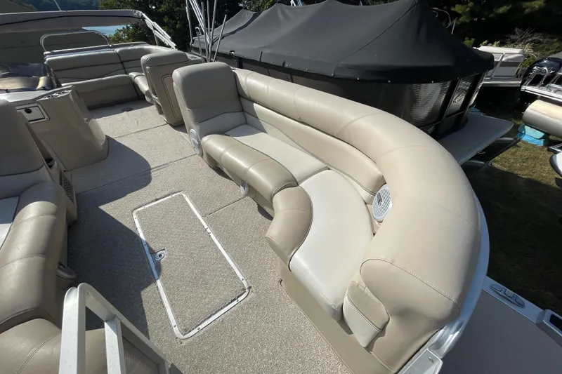 Slide: The Image of 2010 Harris Grand Mariner 240 boat interior with beige seating and carpeted flooring. - 7