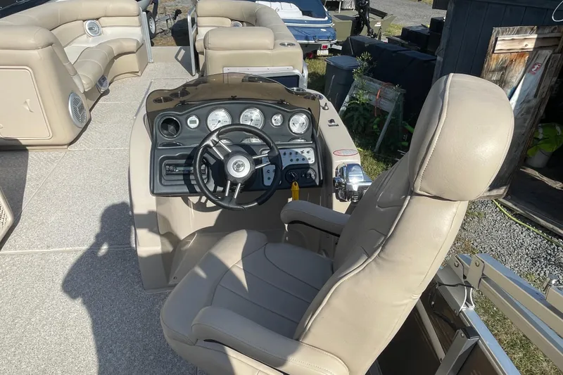 Slide: The Image of 2010 Harris Grand Mariner 240 boat interior with beige seating and control panel. - 8