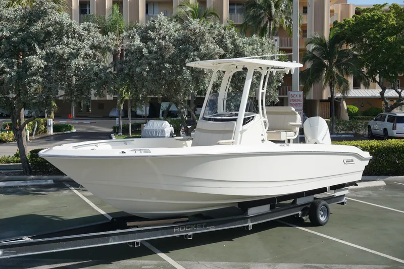 The Image of 2026 Boston Whaler 220 Dauntless boat on trailer in parking lot. - 0