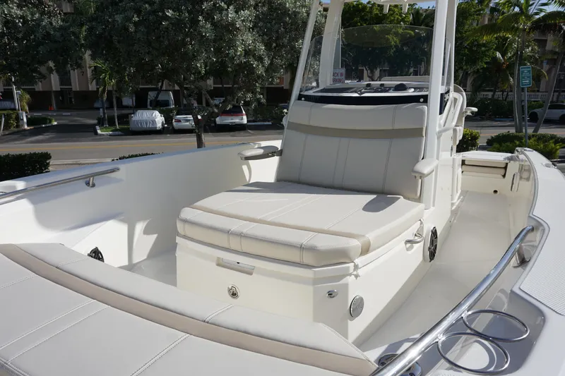 Slide: The Image of 2026 Boston Whaler 220 Dauntless boat interior with cushioned seating and sleek design. - 10