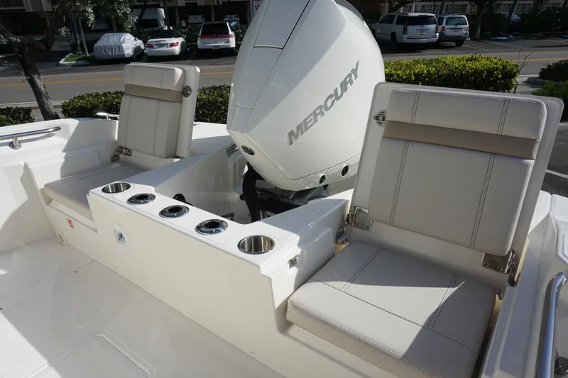 Slide: The Image of 2026 Boston Whaler 220 Dauntless boat interior with Mercury engine and seating. - 12
