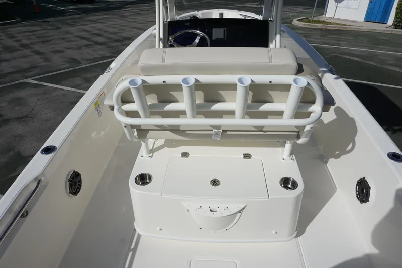 Slide: The Image of 2026 Boston Whaler 220 Dauntless boat interior with seating and rod holders. - 14