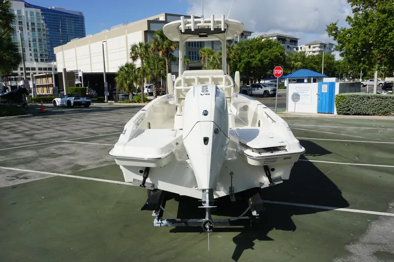 Slide: The Image of 2026 Boston Whaler 220 Dauntless boat parked in urban setting, rear view. - 3