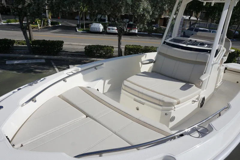 Slide: The Image of 2026 Boston Whaler 220 Dauntless boat interior with cushioned seating and sleek design. - 7