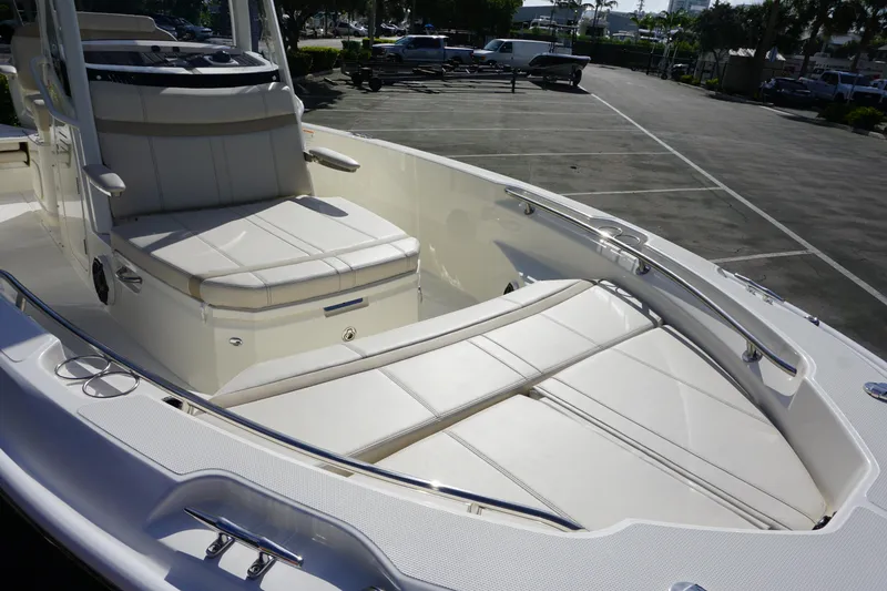 Slide: The Image of 2026 Boston Whaler 220 Dauntless boat interior with cushioned seating and sleek design. - 8
