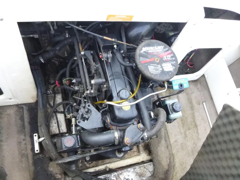 Slide: The Image of 2003 Rinker 180 BR boat engine, featuring a Mercury MerCruiser 3.0 motor. - 13