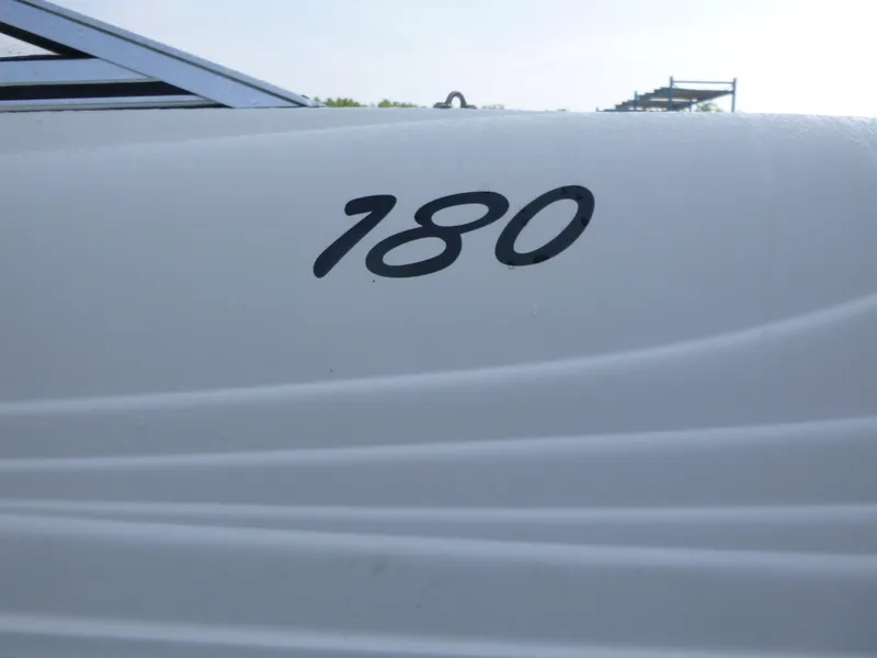 Slide: The Image of 2003 Rinker 180 BR boat with sleek white exterior design. - 15