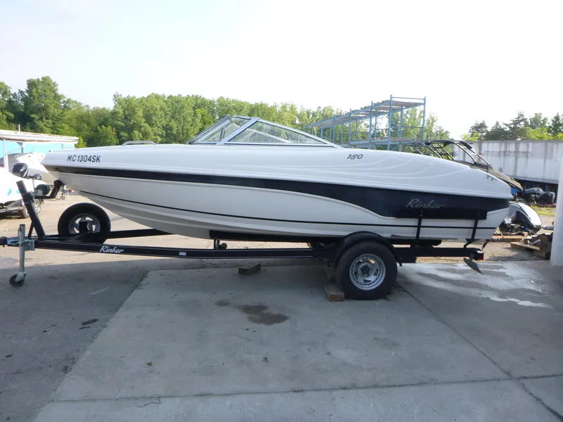 Slide: The Image of 2003 Rinker 180 BR boat on trailer, parked outdoors, side view. - 4