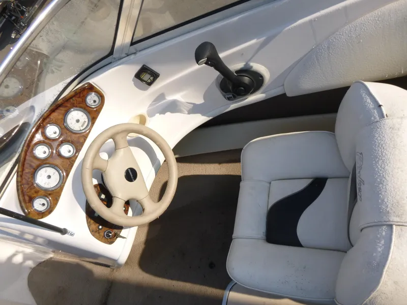 Slide: The Image of 2003 Rinker 180 BR boat cockpit with steering wheel and gauges. - 7