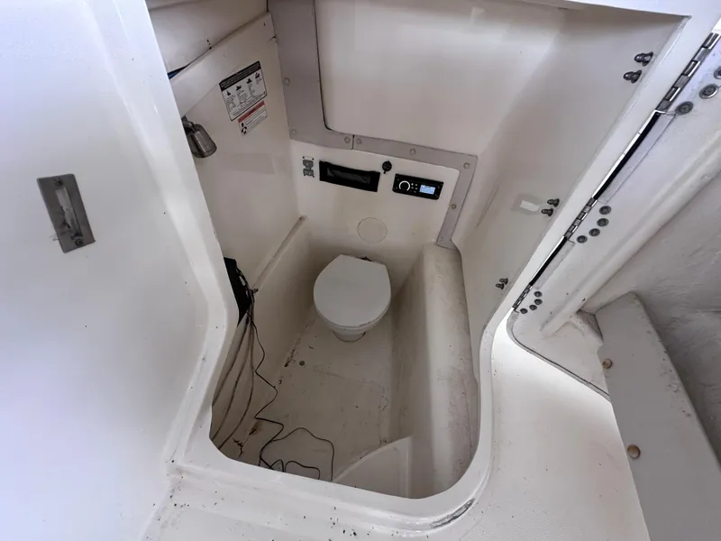 Slide: The Image of 2013 World Cat 255 DC boat interior with compact marine toilet and control panel. - 11