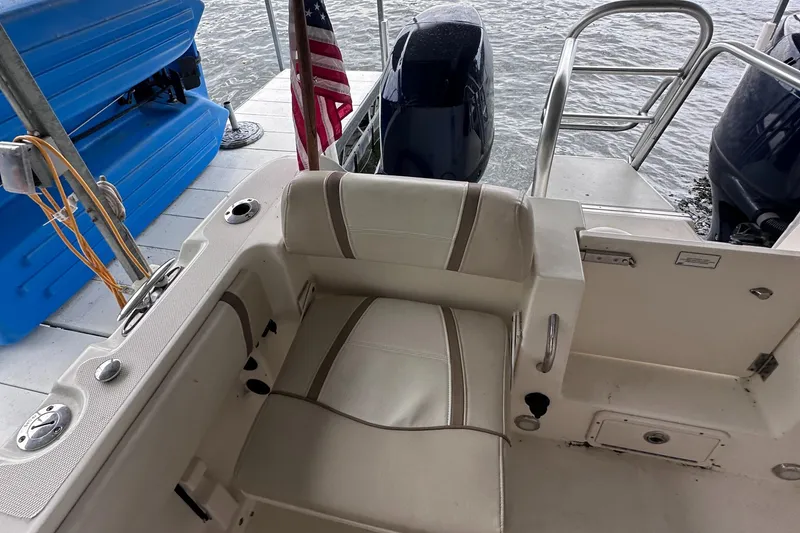 Slide: The Image of 2013 World Cat 255 DC boat interior with seating and American flag. - 16