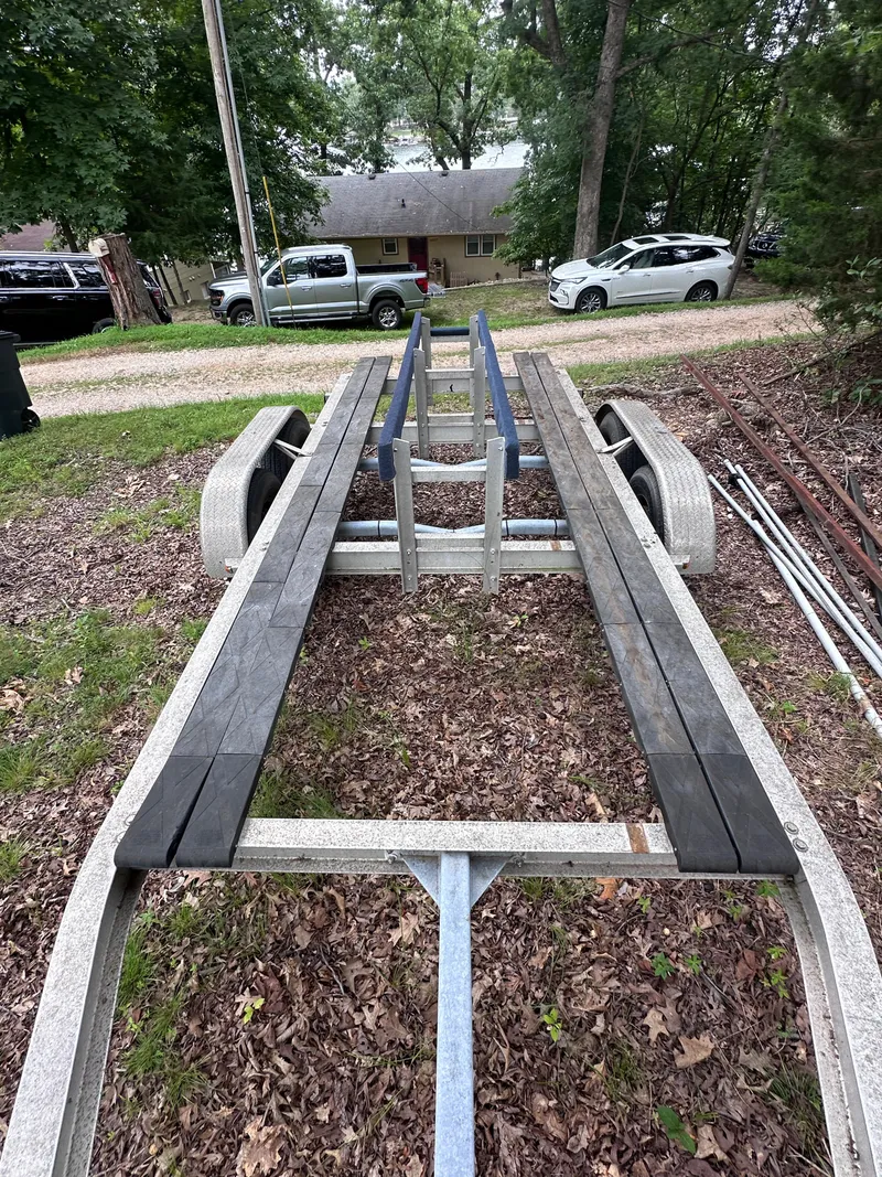 Slide: The Image of 2013 World Cat 255 DC boat trailer parked on leafy ground. - 31