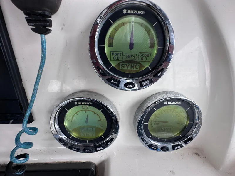Slide: The Image of Suzuki gauges on a 2013 World Cat 255 DC boat dashboard. - 5
