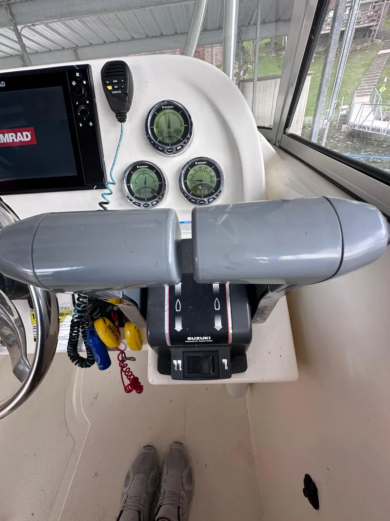 Slide: The Image of Control panel of 2013 World Cat 255 DC boat with gauges and throttle. - 6