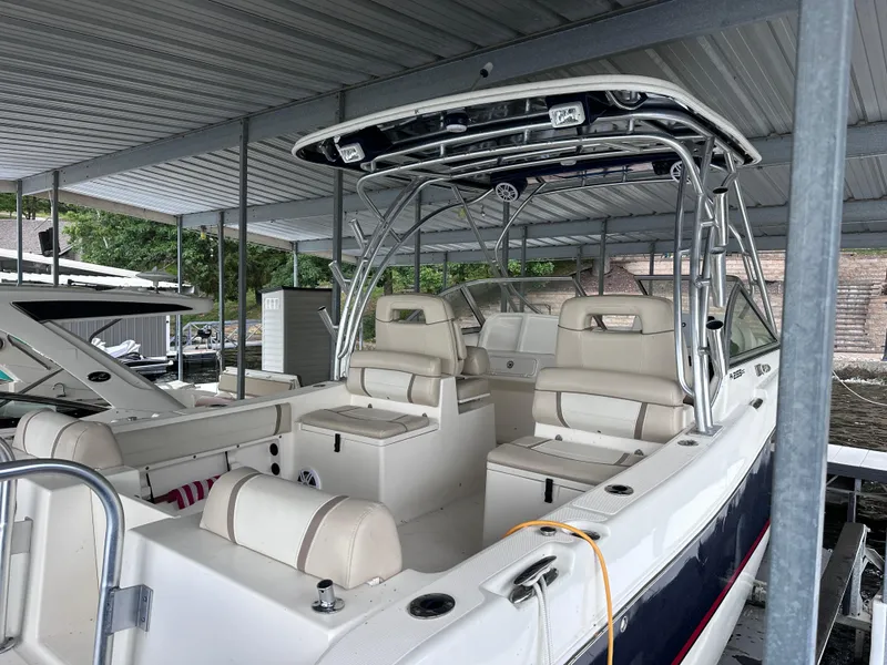 Slide: The Image of 2013 World Cat 255 DC boat with dual console seating under a covered dock. - 8