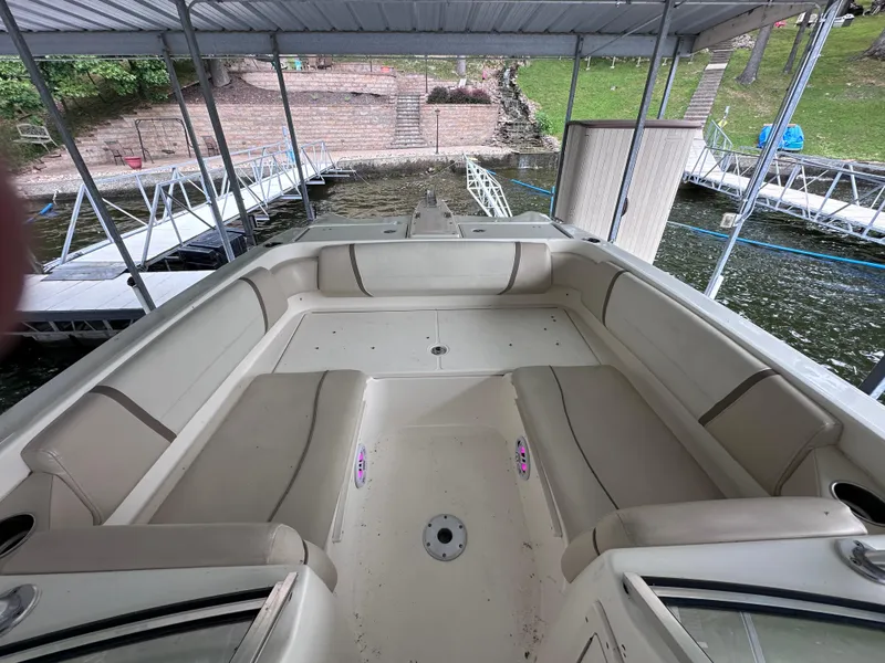 Slide: The Image of 2013 World Cat 255 DC boat interior with spacious seating under a covered dock. - 9