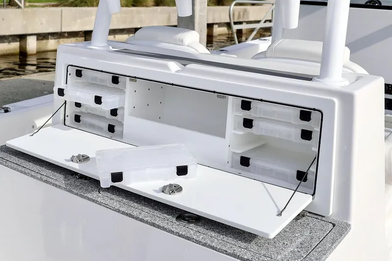 Slide: The Image of Manufacturer Provided Image: 2021 Twin Vee 280 CC GF boat console with steering wheel, controls, and storage compartment. - 11