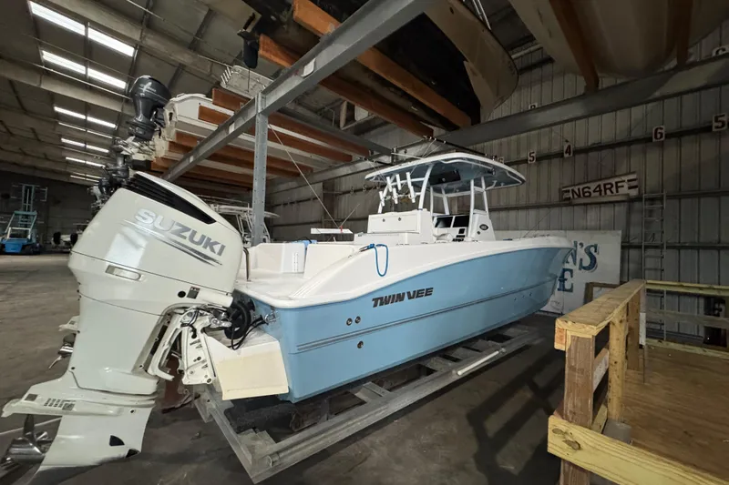 Slide: The Image of 2021 Twin Vee 280 CC GF boat with Suzuki outboard in storage facility. - 18