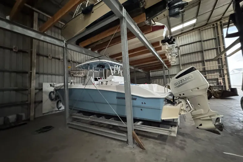 Slide: The Image of 2021 Twin Vee 280 CC GF boat with Suzuki engine in storage facility. - 19