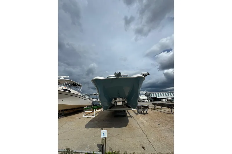 Slide: The Image of 2021 Twin Vee 280 CC GF boat on a trailer under cloudy skies. - 22