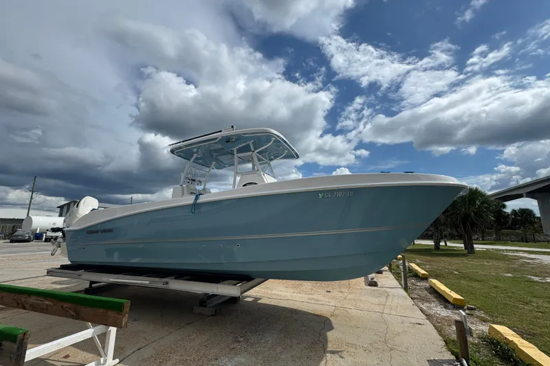Slide: The Image of 2021 Twin Vee 280 CC GF boat on trailer under cloudy sky. - 24