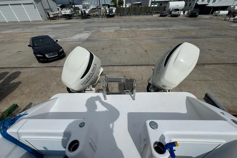 Slide: The Image of 2021 Twin Vee 280 CC GF boat with Suzuki outboard motors in a marina. - 25