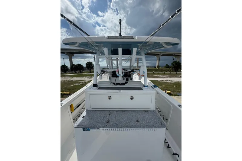 Slide: The Image of 2021 Twin Vee 280 CC GF boat interior with fishing rods and storage compartments. - 26