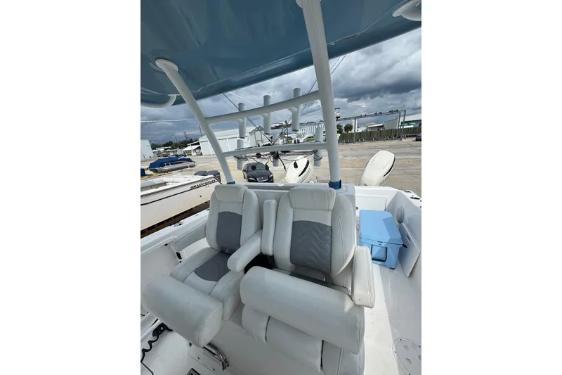 Slide: The Image of 2021 Twin Vee 280 CC GF boat interior with cushioned seating and overhead canopy. - 28