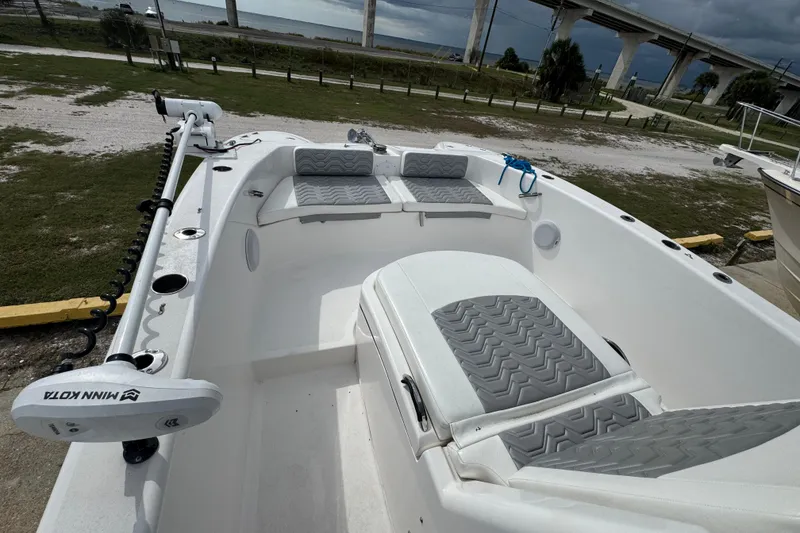 Slide: The Image of 2021 Twin Vee 280 CC GF boat interior with gray seating and Minn Kota trolling motor. - 29