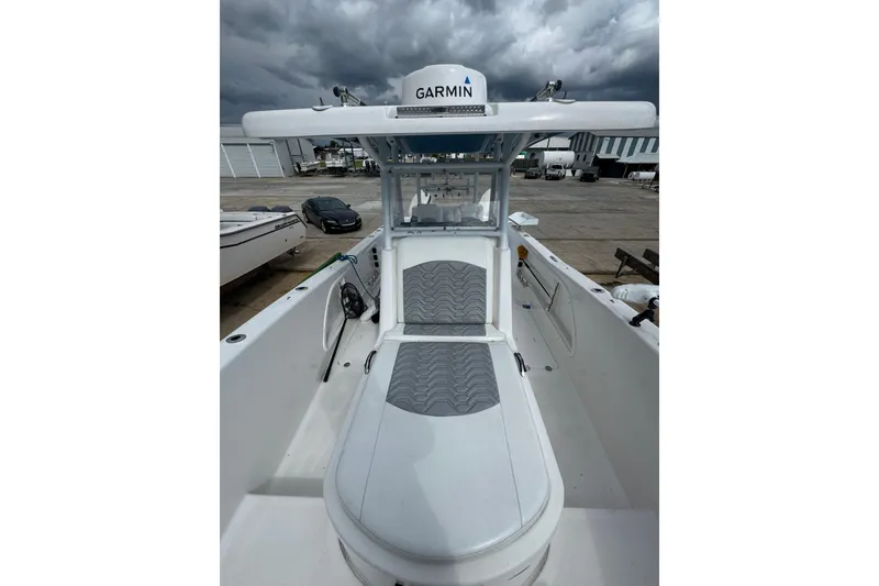 Slide: The Image of 2021 Twin Vee 280 CC GF boat with Garmin equipment, docked under cloudy skies. - 31