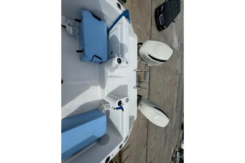 Slide: The Image of 2021 Twin Vee 280 CC GF boat with dual outboard engines and blue seating. - 32