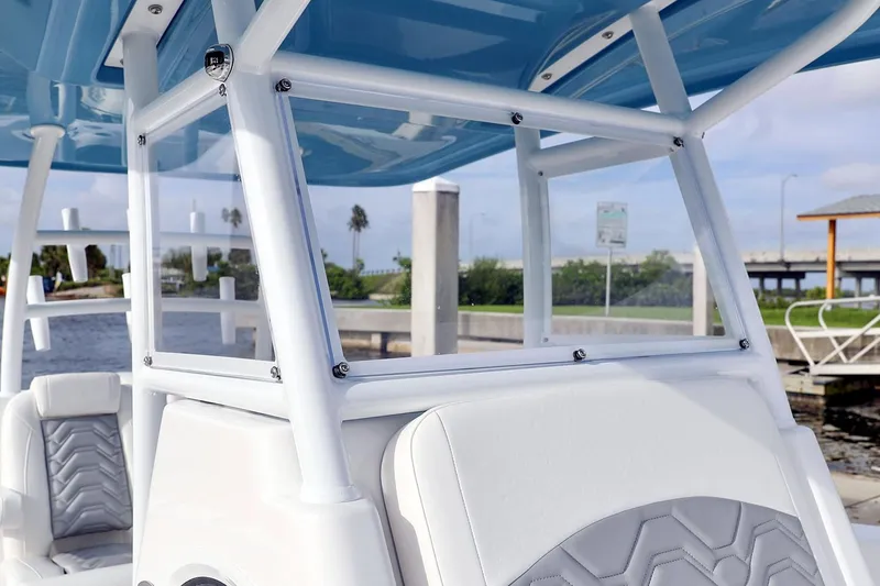 Slide: The Image of Manufacturer Provided Image: 2021 Twin Vee 280 CC GF boat on calm water with lush green background. - 5